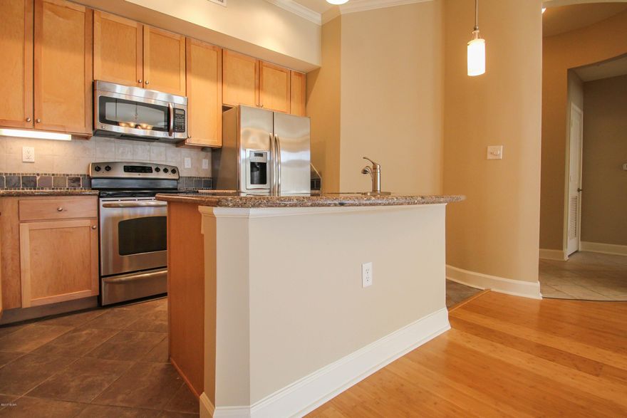 Top floor, all one level,  Great Island Reserve condo has a private location. 5 Star Resort living with 1 acre pool, fitness center, indoor basketball court, and theater with no vacation renters allowed keeps Island Reserve the most sought after community in PCB. This 2 bedroom 2.5 bath condo is located in one of nicest gated communities for condo living 1 mi to the Gulf of Mexico where you can walk in the sugar white sands along the World's Most Beautiful Beaches. There is beautiful Bamboo flooring in the open concept living and dining room areas which flows into the kitchen. Granite countertops and a large island make this kitchen perfect for entertaining friends and family. These luxury 2 Bedroom condos don't last long on the market, LOW ASSOCIATION DUES