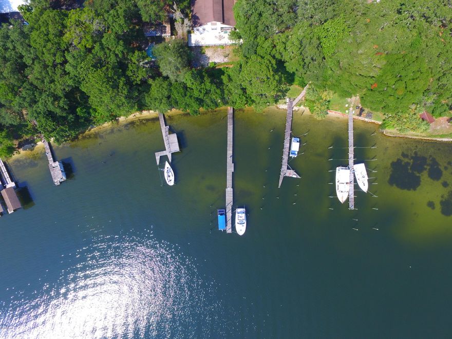 WATERFRONT HOME! LARGE 2693 SF IN THE COVE WITH A 150' DOCK. SELLER IS VERY MOTIVATED! BRING ALL OFFERS!  NEWLY PAINTED INSIDE & NEW FLOORING. Old addition has hardwood floor under the vinyl.  This 4 Bedroom, 2 Bath Home was completely remodeled and new addition added in 2006. Panoramic views of Bayou can be yours from multiple windows in Game Room, Great Room, & Master Bedroom.  WATER FRONT with a 150’ private Dock & 2 Deep Water Boat slips. Dock has electrical & lighting.  Protected deep water Bayou with a 5 min. boat ride to St. Andrews Bay; Shell Island & the Gulf within 20 min.  The home sits 25’ above sea level with a stairway going down to beach and dock area (flood insurance not required).  Original home was totally renovated in 2004 thru 2006 and large new addition. A new addition was added in 2006 including large Game Room, Great Room, & Master Bedroom.  Master Bath features is very spacious with separate tiled shower, large garden tub, & Walk-in Closet - unique wall panel heater for cold days.. Also included with this new addition is a 15' x 60' concrete patio, plus an Open side porch.  Great Room leads out onto a covered wooden deck providing a private view overlooking the bayou.  Upscale Hurricane covers for all windows featuring the latest technology & codes.  Electrical upgraded to 300 amps to satisfy modern demands.  Two A/C's service home; one is 2 years old; one is 10 years old.  Older unit configured to air condition second floor.  The second floor is presently used for storage but could be easily converted to more living space (400 sf).  It is framed out with sub floor.  A/C duct, electrical box is ready for connection.  HOME WARRANTY provided by Seller for 1 Year of protection.   Home appraised at $525,000 2 years ago.  This is great buy at this price. Drive into the circular drive and be prepared to be WOWED... combining the old with the new makes this home a fabulous choice for Cove living.