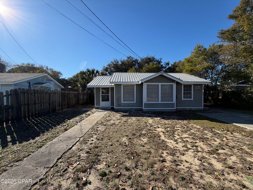 Florida Cottage situated on a nice size lot and a short walk or Golf cart ride to the beach.
Charming Florida Cottage with Metal Roof on Fenced Lot with Mature Oak

This Florida cottage offers comfortable single-story living with a functional layout and coastal character. Situated on a 56 x 120 lot, the property features a fully fenced backyard, highlighted by a beautiful mature oak tree and a storage building for added convenience.
The home includes a durable metal roof, an inviting covered front entry, and driveway parking. Inside, you'll find an open living and dining area filled with natural light thru the original wood framed windows, accented by neutral coastal tones and built-in shelving. The kitchen offers ample cabinetry, a window over the sink, and adjacent dining space.

The home provides two bedrooms with windows on multiple sides and 1 bathroom, with a walk-in shower. Seller has a the side Florida room setup as a 3rd bedroom. Additional features include window A/C units, ceiling fans, original Pine Wood floors throughout. Located in an established neighborhood with easy access to shopping, dining, and local amenities. Property is being sold As-Is.



Buyer to verify all information deemed important.