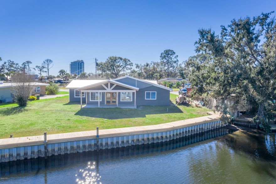 Newly renovated and situated on more than 130' of deepwater, canal frontage sits this 3-bedroom, 2-bath Craftsman style home. This open concept, fisherman's dream has undergone an extensive overhaul including new metal roof, HVAC, electrical and plumbing updates, spray foam insulation, new energy efficient windows, vinyl and tile flooring, granite countertops, new cabinets, master suite with massive walk-in closet and custom tile shower. Seller has added custom touches throughout including ceilings with tongue and groove cypress and blue stained pine, vaulted porch ceiling and sinker cypress front and rear door. Outside you will find a newly installed seawall with decking, 2 car garage, fresh paint and breathtaking views of Harborage Marina. Home is tucked away in Woodlawn Subdivision , just a short drive to shopping, dining and the worlds most beautiful beaches.