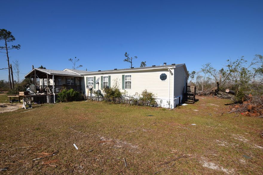 CURRENTLY UNDER CONTRACT, SELLER ACCEPTING BACKUP OFFERS.  2 homes sitting on almost 5 acres with pond. 1 home is livable and other home sustained damage from Hurricane but appears it can be fixed. Both homes are same floor plan. Spacious with living room and den that offers wood burning fireplace. Large eat in kitchen with island and pantry.  Vaulted ceiling. Master suite with sitting area that can be used for office or reading nook. Garden tub and separate shower in master bath.  Covered front and back porch and double carport.