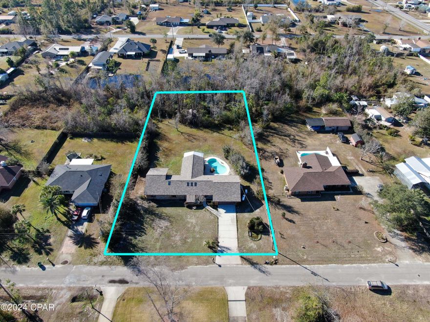 CURRENTLY UNDER CONTRACT, SELLER WILL CONSIDER BACKUP OFFERS STUNNING one of a kind home sitting on over an acre; there is NOTHING this home is missing! Featuring 4 bedrooms/2.5 bathrooms + Office + Pool + Gym/Bonus Rm + Sunroom. This fully renovated open concept floor plan will draw you in with it's inviting modern design. Tall cathedral ceilings and skylights sit above a sunken dining or living area; overlooking the large living room featuring pool views, and a beautiful beamed ceiling. Chefs dream kitchen with an abundance of custom cabinetry, Quartz countertops, stone backsplash, kitchen island/bar with stove top, stainless steel appliances, double oven, pantry, and recessed lighting. Situated off the kitchen sets the laundry area with utility sink and cabinetry; 1/2 bath; garage/backyard access, AND a office. Off the living room sits the bonus room converted to a gym with large glass windows overlooking the pool for a bright and airy space. Past the gym you will find the screened in patio with utility sink and window unit. Featuring tile flooring and relaxing 180° views all around. Master bedroom features a window nook, walk-in closet, and tile bathroom with custom cabinetry, double vanities, tiled tub/shower combo with glass door and oversized 6 ft whirlpool tub; double shower-heads including a rainfall showerhead. 3 secondary bedrooms are all spacious in size with full guest bathroom featuring quartz, floor to ceiling tiled shower with glass door and rainfall shower-head. As if you needed more...this home comes with the generator as well!
Call to schedule your private showing today! All Measurements approx. buyer to verify if​​‌​​​​‌​‌​​​​‌​​‌​​​​‌‌ important.