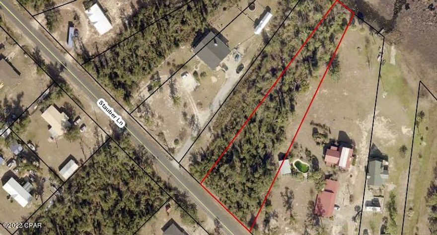 All sizes are apx taken form tax records/// Wooded lot on beautiful Bear Creek--which runs into Deerpoint Lake!! Many of the tree's are down from hurricane Michael:  Priced right for quick sale!!  Easement is west of the property that would be a good buffer--supposed to be maintained by the county, but is overgrown at present!