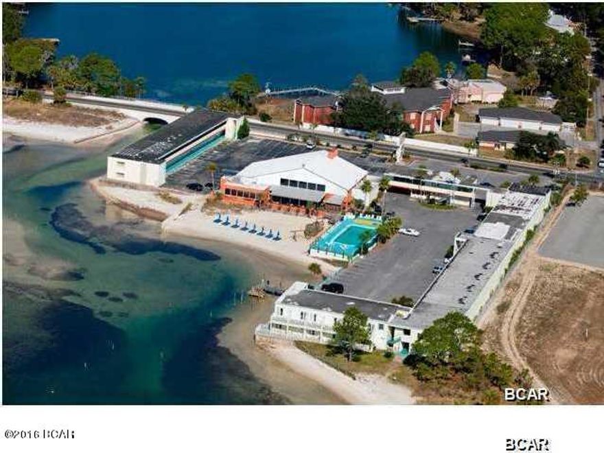 RARE OPPORTUNITY.................. To own large tract of St. Andrew Bay water frontage that includes over three (3) acres and has 800' with white sandy beach, which is zoned general commercial with 45 unit per acre density and located at the Western gateway of the downtown CRA (Community Redevelopment Authority) that will allow the buyer / developer to take full advantage of current revitalization taking place in downtown Panama City, FL. The property is currently fully operational as the Buccaneer Beach Motel & Bar & Grill. Consisting of Five (5) Buildings - 54,062 SF total; built in 1960; concrete foundation, roof and walls and seawalls; restaurant is brick and frame w/fire pit; 90 kings or doubles, 11 suites, 101 total units and 10,500 square foot restaurant/bar with up to 290 More...