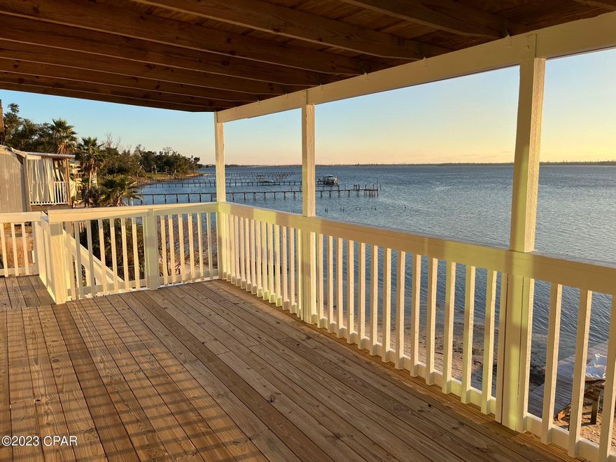 INVESTORS! INVESTORS! RENT ONE UNIT LIVE IN OTHER HAVE YOUR MORTGAGE PAID FOR! Eastside Bayfront waterfront 3 story townhome with direct access to the Gulf of Mexico. Only 5.5 miles to Tyndall A.F.B. Has its own private beach! Only a short distance to Sacred Heart Hospital. Hidden behind a high retaining wall this townhome is a private getaway with Magnificent Sunsets from the West. NO HOA, SHORT TERM RENTALS ALLOWED(AIRBNB). 1/11th ownership in the dock which is being extended another 60 feet will be deeded at closing. NO FLOOD INSURANCE REQUIRED! New metal roof put on 2019, New Water heaters installed 2021, New A/C and HVAC for upstairs 2018. New mini split HVAC for a/c and heat for downstairs unit 2021. New Hardy Board siding 2021 Top 2 floors with fresh paint. Bottom floor Stucco repaired and painted. All new staircases and balconies completed and permitted in 2020. Upstairs appliances 2020. Downstairs appliances 2021.Upgraded electric service and added ceiling fans. Sewer line just serviced a week ago. New High impact Hurricane rated windows and sliding doors installed 2021. A TURNKEY PROPERTY!
The Upstairs unit boasts 3 bedrooms 21/2 Baths with a Balcony off the Master Bedroom and Balcony off the spacious living room both with magnificent sunset and water views. Kitchen, living room and half bath on the top floor and Bedrooms and baths, laundry with new washer and dryer, second floor. High ceilings accent the main living area with an open concept. Very first floor houses an efficiency apartment with 1 bedroom 1 bath, kitchen and living room again with views of the Bay and sunsets. This unit has a washer and dryer of its own. Live in one unit and rent the other or rent both units, your choice, no restrictions! Long term rental Potential Income $4,000 a month. $1,500 for 1 Bed and $2,500 for 3Bed. Fresh paint inside was done recently. A MUST SEE! Buyer and Buyers agent to verify All dimensions and anything deemed important.