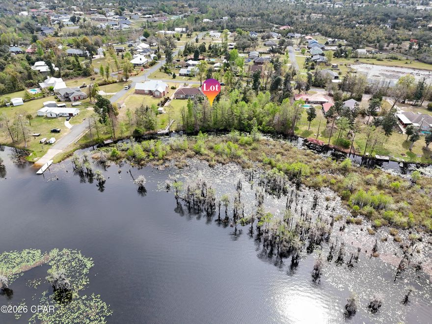 Build your dream retreat on this exceptional 0.58-acre canal-front homesite offering 100 feet of water frontage with direct access to Deer Point Lake. With serene water views & ample space to design your ideal residence, this property provides the perfect setting for a private dock, pool, workshop, or additional outdoor living features. Deer Point Lake is a 5,000-acre freshwater reservoir, formed by damming Econfina Creek, Bear Creek, and Cedar Creek, and is widely known for its outstanding fishing, boating, kayaking, and paddle boarding. Whether you envision a full-time residence or a peaceful weekend escape, this location delivers both recreation & tranquility. Conveniently situated approx 150 yards from the public boat ramp at Cedar Creek, water access is effortless. For those seeking even more space & expanded waterfront, the adjacent lot is also available, presenting a rare opportunity to own a combined 1.15 acres with 200 feet of canal frontage. This prime homesite makes an exceptional canvas for your waterfront vision with direct lake access, generous acreage, and expansion potential.