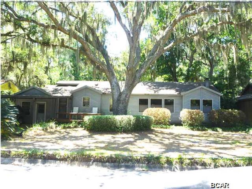 BEAUTIFULLY UPDATED KITCHEN in this spacious home in the coveted Cove area! Huge Cambria Quartz island in the kit will no doubt be the hub of all activity in the home. A lot of cabinets for storage and counter space (all Cambria), accented with a beautiful glass tile backsplash will encourage your culinary skills! There is a desk area for meal planning! The Wolf gas range/oven will convey only with an accepted offer. However, the Wolf range hood will convey with the home. Skylight in the entry adds a lot of natural light. There is a dining area that will fit a large table. The den has engineered hardwood flooring, chair rail, new shades and a pot-bellied stove that will keep winter days cozy. The addition off the back of the home has a cathedral ceiling with several skylights and