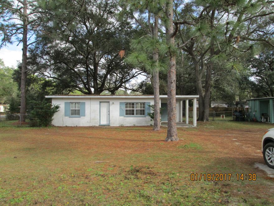 Make this Block Home your very first potential flip/rental investment!! This Corner Lot features a spacious fenced in back yard as well as a carport. Home/lot is nicely shaded with large oak trees. New front door and water heater installed in 2016. With a little love and an eye for detail this home could be a real gem. All measurements, zoning and sizes are approximate. Please verify if important.