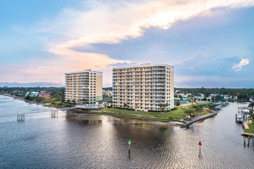 CURRENTLY UNDER CONTRACT, SELLER ACCEPTING BACKUP OFFERS Updated first floor 2 bedroom / 2 bath unit  at Hibiscus by the Bay including a nice boat slip. No need to take the stairs or elevator and stunning views from the balcony of St. Andrews Bay! The unit has a nice open floor plan with updates including new floors, new paint throughout, and a new shower in the master bath. Kitchen looks out into the dining/living area, has stainless steel appliances, and granite counter tops. You have incredible views of the Bay from the kitchen/living area and the master bedroom. The development also boasts a 500 foot long fishing pier, garages for purchase, a marina with boat slips available for purchase or lease, a tennis court, an exercise room, a hot tub and pool; making Hibiscus a beautiful place Just minutes from the beach.