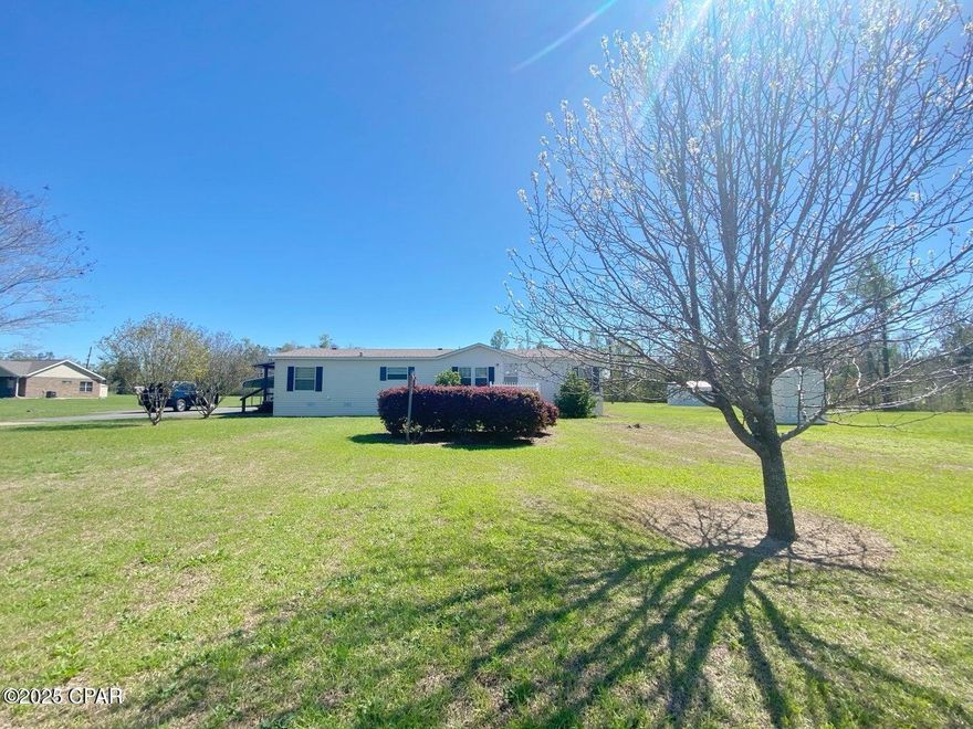 MOTIVATED SELLER!  
Convenient peaceful setting only a few miles outside of Marianna! The setting on over 6 acres will charm you with so much space to grow a garden, have pets, or just enjoy! There's a carport just off the drive w/ attached storage building w/ electricity, an underground storm shelter, & lovely gazebo. A large covered deck was built on the back of this home to enjoy the outside. Inside you'll find 2 bedrooms each with their own bathrooms. The floorplan is nice & open w/ plenty of space for casual living. If you love to cook, this kitchen is spacious enough to host a small eat-in table, separate wetbar area w/ extra sink & a

3rd bedroom was converted to create a generous laundry room/ mudroom w/ walk in pantry! The home has gas cooking, & a new instant Rinnai water heater. The master features a vanity w/ lots of counter space, garden tub, & separate shower. HVAC & roof are only 5-6 years old. Land is all in Flood Zone X, which is outside of a flood plain. (see aerial attached on photos)
All kitchen appliances, storage sheds, and clothes washer and dryer will convey making this home all ready for a new occupant.  Other furnishings may also convey with acceptable offers.