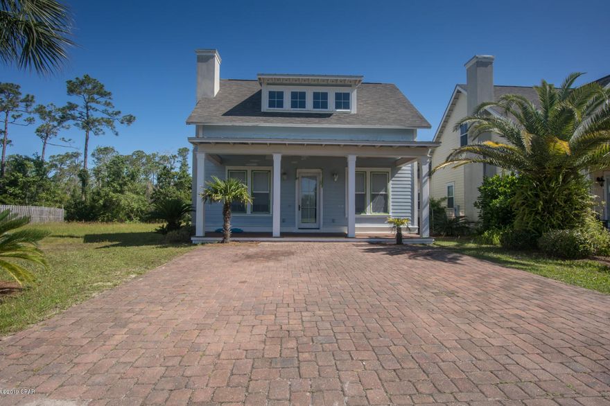 The first floor of this home offers a living room with fireplace, dining area, half bath, LARGE laundry room, master suite with large master bath.. Second floor has two bedrooms with another full bath and an open area in the hallway large enough to make a home office and finally a large fourth bedroom or big enough for a game room or media room. Granite everywhere, designer cabinets, custom windows, covered front porch, double paver driveway, custom tile throughout most of the downstairs, crown molding, 10' ceilings, b board wainscoat, recessed lighting, breakfast bar---quite a home.You can walk to Shipwreck Island Water Park, few minutes to Pier Park and just a few steps down from the community pool. There is a new exterior paint job going on now!
