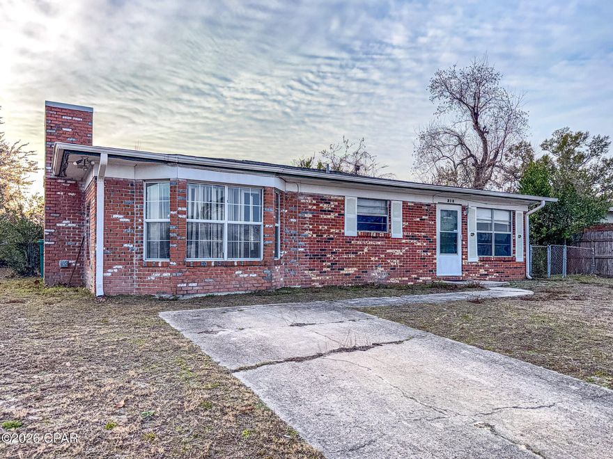 Solid brick home in well established neighorhood with a long-term rental history, offering strong potential as a buy-and-hold rental or value-add renovation. This 4-bedroom, 2-bath property features a separate family room with a fireplace, offering a flexible layout that's comfortable for everyday living and appealing to both tenants and future owners. The open kitchen and dining area with breakfast bar connects the main living spaces, while numerous windows throughout the home provide abundant natural light. Major capital items have already been addressed, including a roof replacement in January 2019 following Hurricane Michael and a water heater replaced in 2016. Appliances are present and operational. Interior improvements are needed, including minor drywall repair, ceiling finish and paint, flooring replacement in select areas, and a good coat of paint on the interior. Fenced backyard includes a 20x12 storage shed/workshop. Located in a well-established neighborhood close to Tyndall Air Force Base, shopping, schools, parks, and boat launches—an area that continues to attract long-term rental demand. Property is being sold as-is. Well suited for investors, renovation buyers, or owner-occupants using conventional or renovation-type financing. Contact your favorite Realtor® today for a showing.