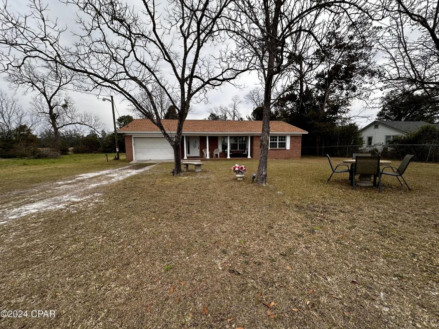 2/2 brick home with garage conveniently located in Marianna close to the schools and town. Home is move in ready with all new tile flooring, new roof, and appliances. The kitchen is very spacious with built-in shelving and leads out to a large sunroom on the backside of the home.  There is a full second bath in the laundry area. The 1.2 acre parcel has two wells (owner doesn't know if they work). Make an appointment to see it!