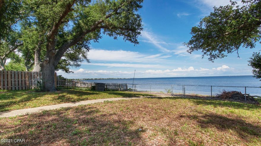 Unbelievable view of East Bay from this well maintained WATERFRONT home. Enjoy your morning coffee on the back porch or beach watching the beautiful sunrises of Florida. The updated kitchen with granite countertops and breakfast bar will be everyone's favorite hangout looking out at the bay. The water can be seen from almost every room in the home. The newly carpeted bedrooms, family room and hall add warmth and comfort. Freshly painted with a warm neutral color that will match any home décor. Home is located a short 5 minute drive to Tyndall Air Force Base, close to schools, parks, boat landings, restaurants and shopping. Launch your paddle board, kayak or jet ski right from your back yard or enjoy quiet campfires next to the water. The home is located in a flood zone X so it does not require flood insurance. Home is set back off Hwy 98 with a long driveway, so there isn't noticeable road noise. Fenced in back yard with shade trees is perfect for kids and pets alike. All measurements are approximate, please verify if important. Contact your favorite Realtor today so you don't miss out on this lovely waterfront property.  ***The purpose of this sale is to accomplish a 1031 Exchange.***