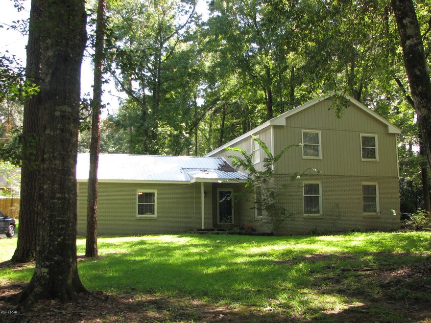 Nice, spacious home located in a quiet neighborhood inside the city limits of Marianna. This home would make a perfect home for a large family. The garage was converted into a nice family room that is great for entertaining guests. This home features a large kitchen, multiple living areas, an office and a formal dining room. All 4 bedrooms are spacious with the master having its own large master bath and walk-in closet. The master also has a large deck with French doors leading out back.(Deck needs some work) This home sits on a large lot with plenty of space for kids to play.