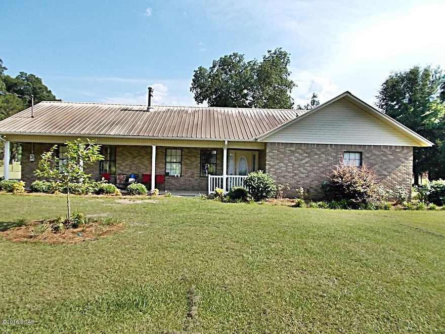 Looking for privacy in a nice brick home just minutes from I-10. This home is a very nice brick home, nestled behind beautiful oaks just off the highway, kitchen has tile floors, stainless steel sink,breakfast bar, large open floor plan making it seem larger  than it is, wood burning fireplace in living room. Natural lights come into french doors to light up the dining room large master bedroom with a nice master bath and master closet and master dressing room.There is also a 30x60 metal building with concrete floors and 3 roll up doors and 2 walk thru doors all ready set up with elec and water, and a 10x30 lean too attached, call agent to view this home, it is very unique.