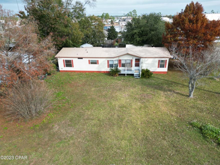 'CURRENTLY UNDER CONTRACT, SELLER WILL CONSIDER BACKUP OFFERS' This spacious mobile home is priced to sell and located just 10 minutes from Panam City in the popular Sweetwater Village. This 3-bedroom 2-bath home has 1723 sq. ft. of living space. The high ceilings and open concept offer 2 living areas divided by a double fireplace which allows you to move effortlessly from one room to another and gives the sense of a large continuous space. The sizeable eat-in kitchen is well designed with numerous cabinets making it perfect for those who love to cook. The large master bedroom has a great bathroom with enough space for a dressing area and walk-in closet. This is a split bedroom floorplan allowing private spaces which makes it ideal for multi-generational households. This home has had some flooring upgrades and a new Ac in the last year and is priced to sell for additional upgrades. Other benefits include cinder block stem wall supporting the home, a Florida room, 2 decks, yard well, workshop, double carport, large corner lot, and a great neighborhood! Motivated seller! Bring all offers!