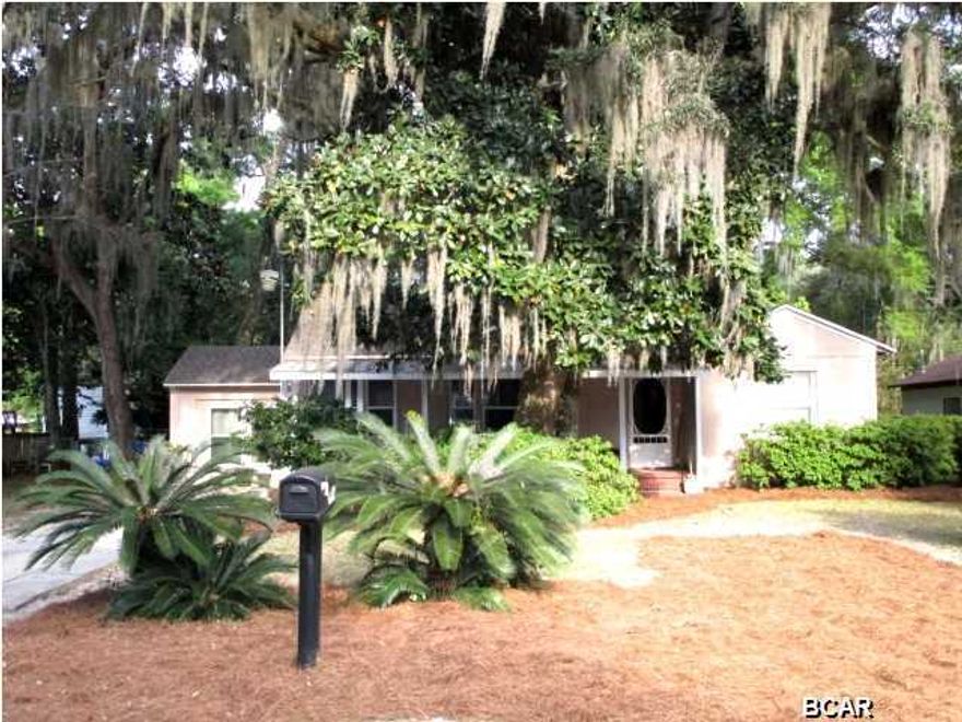 ABSOLUTELY CHARMING COVE HOME that features three bedrooms and the possibility for a fourth with beautiful hardwood floors throughout the entire home! Features include a spacious living room with a French door that accesses the private office, a dining area with French doors that overlook the outside wooden deck, and an updated kitchen with built-in microwave. The Master bedroom has a vaulted ceiling and the Master bath has a combination shower/tub, walk-in closet and a stackable washer and dryer that remains with the home. This split bedroom plan offers two additional bedrooms and a beautifully updated full bath with marble floors. But, if you need that extra bedroom, the large second bedroom was actually two smaller bedrooms and the casing remains, so it would be easy to convert it