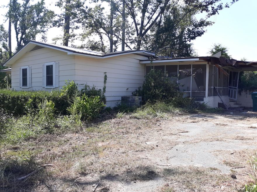 INVESTMENT OPPORTUNITY, 3 acres on paved rd built in 1970 with new well in 2017. House was damaged by hurricane and needs roof repair on one end along with Porch and car port area repaired. . Also has additional storage building away from main house that was not damaged. Home has circular driveway that is paved.  House has 3 bdrms and 2 bths. Has shop on property that was not damaged, except for covered awning over parking. Has inground liner pool that was damaged by hurricane with deck.
