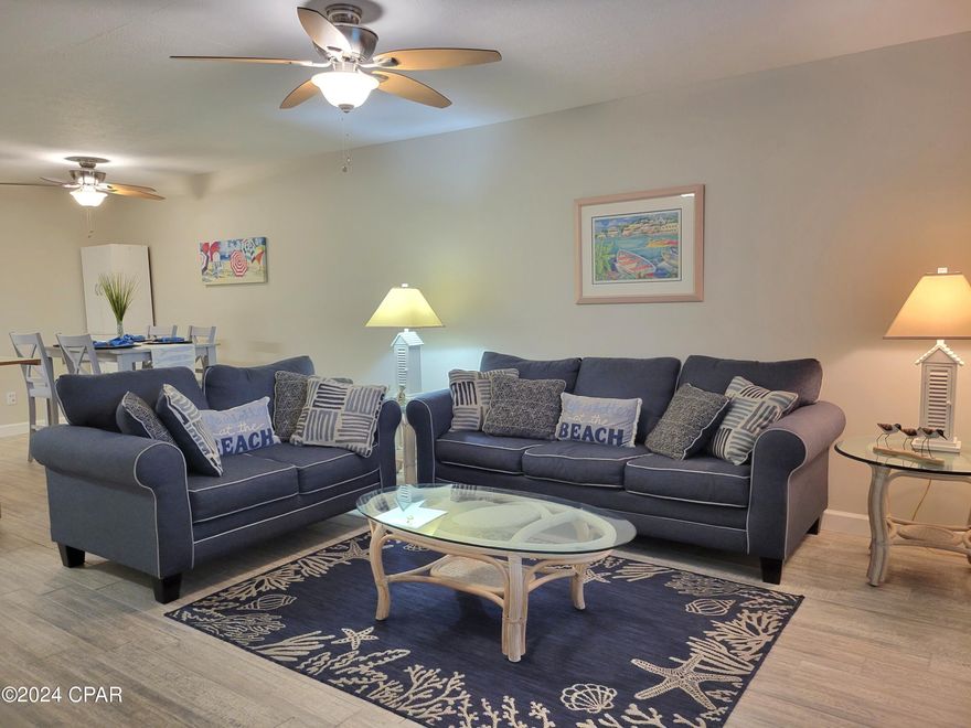 Adorable, fully furnished townhome that boasts exceptional rental projections and is a short walk to the beach!   Updated double-paned, double-hung windows and a metal back door.  Enjoy outdoor living with a screened-in back porch and balcony.  Fresh paint throughout, ceramic wood plank tile floors down, hardwood stairs and VPC wood plank flooring up continue the stylish theme.  Attic has been planked over the living and kitchen areas, providing extra storage and enhanced R11insulation.  Golfcart friendly community offers 11 pools (5 heated), shuffleboard, tennis, beach house/cafe, mini golf, exercise room, playground, wifi, cable, trash, termite bond, pest control, property patrol, gated community.  Furnishings convey with sale.  Buyer to verify all information.