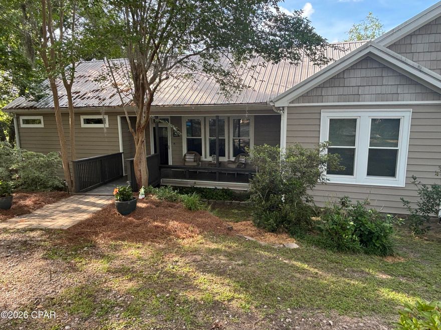 Welcome home to the highly desirable Compass Lake Community! This wonderful waterfront property is a MUST SEE! This listing includes the waterfront home, a huge barn, and  a guest house on 3 acres!

The waterfront home was tastefully renovated in 2019 with many upgrades such as the metal roof, HVAC system, storm windows & LVP flooring throughout. The stainless steel appliances were purchased in Dec of 2025, as well as a new water heater. The picture windows give you ample natural light throughout the home to enjoy gorgeous lake views from the primary suite, living room, den, dining room and the kitchen. You will love the oversized screened in upper deck that is perfect for entertaining! In the backyard you'll enjoy the large covered patio with plenty of space for outdoor living, along with an outdoor shower for your convenience after a day out on the lake.  The 300sf dock house with enclosed porch, 2 docks with a boat shed and a shared dock gives you more than enough room for your boats, jet ski's, and storage for your all of your lake supplies.  

The 2944sf barn - (Parcel ID-06-2N-11-0307-00B0-0060)
has a large loft area and a full bathroom. There is room to store your boats, golf cart, jet skis, and even an RV!  Approx. 850sf of the barn is heated and cooled. There is an additional storage shed that is heated and cooled near the big barn.

The 1 bed/ 1 bath cabin (address is 2677 Lakeview Circle- Parcel ID 06-2N-11-0000-0060-0012) was the original home on the water here, and has since been moved up the hill. Built in 1962, it has it's original charm, but includes several modern upgrades.  This adorable home would make a perfect Air B n B rental, or a wonderful guest house for family and friends. It has amazing views of the lake, and woods in the backyard so you are soaking in all of nature with an abundance of wildlife.  The cabin also has an outdoor shower and large screened in porch for taking in the scenery.
The home and cabin both have termite bonds, and there is a water filtration system on the deep water well.

The Compass Lake community has NO HOA but there is a public boat ramp for your use, and a Members Only boat ramp for those that join the boat club.  Homes on Compass Lake rarely are available for sale, as they are passed on through the generations.  This 700 acre spring fed & crystal clear lake is a great place to enjoy boating, skiing, wakeboarding, canoeing, paddleboarding, & fishing.  This quiet and picturesque community on Compass Lake is the perfect place to call home. If you love nature and the outdoors, then this is the home you've been looking for! 

 GO SEE this amazing property today!
 All measurements are approximate, please verify if important.