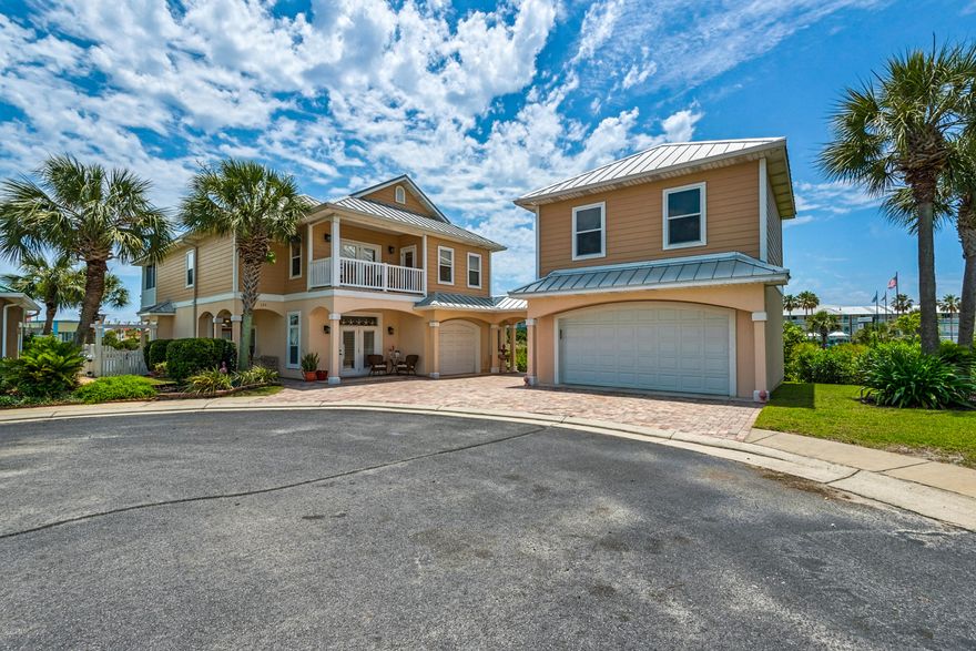 Lakes at Summer Breeze. Gorgeous views  to the Gulf. Custom built with carriage house, room to spare, 2,888 SF main house, 4 BR's, 3 baths and 1.5 car garage. Plus 2 car carriage house & 441 SF bonus room above. Pavered patios and landscaping enhance the views.  Open floor plan, high ceilings, abundance of windows bring the outdoors in. LR w/gas fireplace, updated Chef's kitchen, custom cabinets, gas stove and easy access to the huge covered  patio. First floor guest BR with french doors to patio and full bath with antique vanity. Upstairs the master suite is huge and beyond compare with more hardwood floors, a study,  gorgeous bath and a balcony across the entire width of the house. It will be your favorite spot. Another bedroom, full bath, wet bar and lounge with bunks...to much to list.