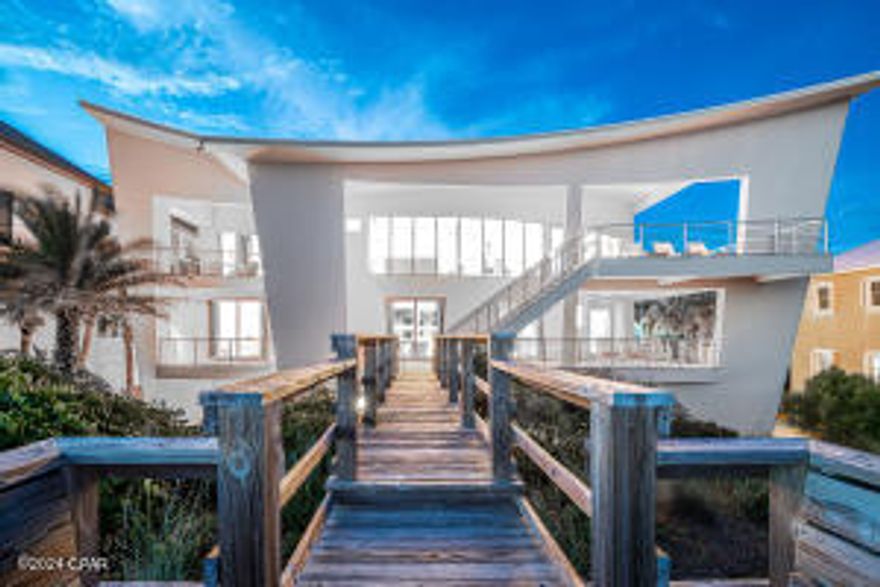 Stunning home with a rare 90 feet of gulf frontage in the gated and rental restricted neighborhood of Gulf Dunes. This 5 bedroom + office home has 6 1/2 baths and offers 4 gulf front suites with direct balcony access. Private pool and hot tub, elevator, ample parking, private beach walk over and generous outdoor spaces are just a few of the special features. Blending cutting edge contemporary architectural design with cozy comfortable interiors makes this one of a kind home truly unique. The third level is comprised of the owners suite with private balcony, large living/dining/kitchen area with solid walls of glass, soaring ceilings and office. The 2nd level has 3 ensuite bedrooms, den and laundry. The 1st level has a game room, bedroom and 2 full baths, one adjoining the pool terrac