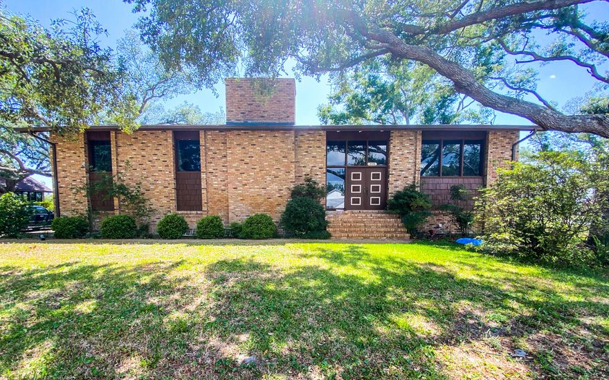 Investors!  This is a must-see property.  Beautiful older home in a great neighborhood on a fantastic Â½ acre lot with a lush yard and lake view.  The home is a split-level design with open beamed ceilings, fireplace, wet bar, tons of storage and lots of character.  4 bedrooms, 3 baths and lots of storage space.  The home sustained minimal hurricane damage, and all repairs have been made including a new roof.  This home needs to be rescued from the 1970's!