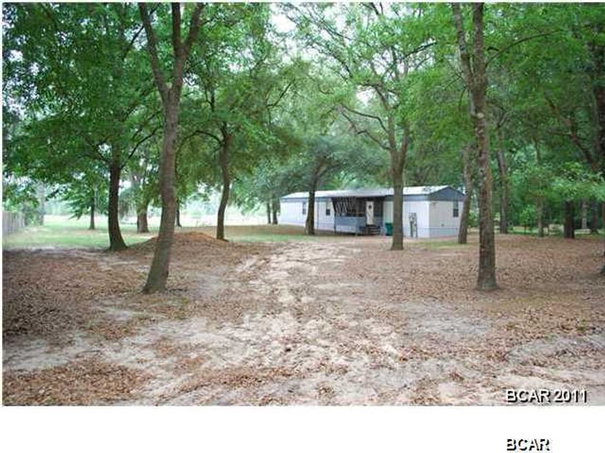 This is a neat, clean, nice single wide in a country setting where you can enjoy the simpler life. A few shade trees make this lot both comfortable and beautiful to enjoy the view of the pond in your own back yard. Enjoy the luxury of having a garden tub with separate shower and double vanities. A screened porch on the side of the home allows for viewing of all the great outdoor activities you'll enjoy while owning this peaceful country life. There is a split floor-plan and laundry inside next to the kitchen. Brand new A/C unit installed Feb. 2016! This property has plenty of storage both inside and outside with an additional storage building. Come get away and feel like you're on vacation in the country!