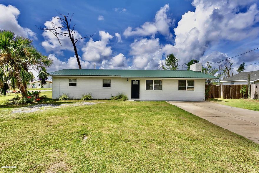 This Lynn Haven home, situated on a large corner lot, has gone through many updates and upgrades over the last few years. This solid brick home, with a metal roof, is easy maintenance with newly installed laminate flooring in the living room, hall, and bedrooms (no carpet). The kitchen was upgraded over to the last few years, and the home features newer windows, doors, light fixtures, a half-bath added, newer extended driveway, and a newer AC in the Florida room. The bedrooms are to the left of the home, and the oversized living room is 25.7x17.7, with a beautiful stone fireplace. There is also a finished bonus room off the back of the home that is heated and cooled, featuring a wet bar, cabinets and storage. This room could be used as a 2nd den, game ENTER ON MORE* room, or so many different options. The full bath has been upgraded to include a large walk-in shower, tile flooring, and a granite countertop vanity. Not only is there a bonus room attached to the home, there is a detached garage with an attached finished bonus room that has a heat/air system, which would make a great bonus room or workshop. It needs a little bit of work to the ceiling but should be an easy fix. With no association, this large corner lot has so many uses. If you have an RV, boat, or trailer, no worries you can drive straight to the backyard for storage. The newly built brick fire pit is large enough to invite all your friends and family for a social gathering. If this sounds like the home you have been waiting on call your Realtor to setup a private showing before your dream of owning a piece of paradise becomes another buyers Reality! Age, Sq.ft., Room Dimensions, Schools, taxes, or any important information to the buyer must be verified by a formal or personal inspection.