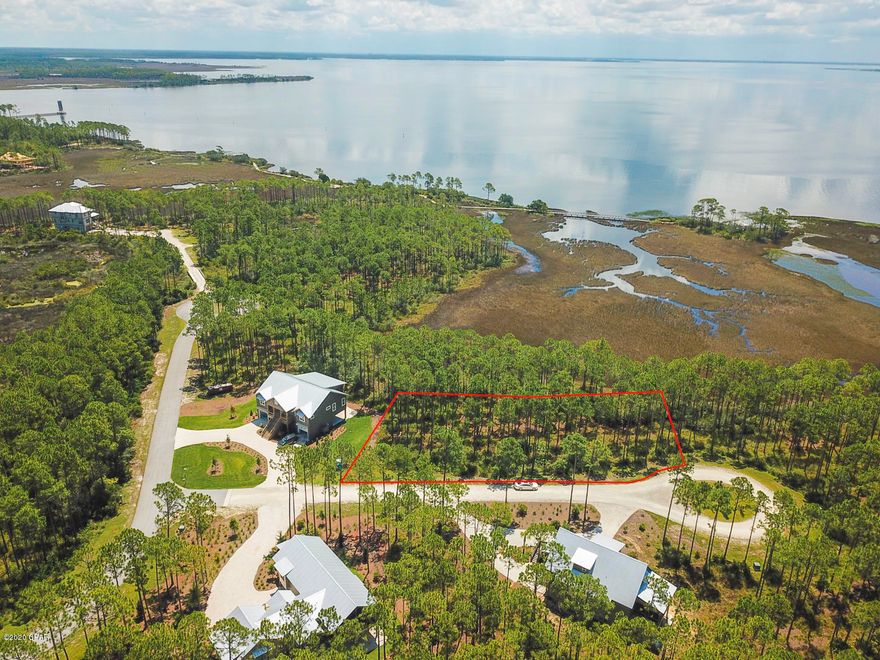 This is a prime lot that overlooks the tidal marsh located in RiverCamps, an exclusive St. Joe waterfront community, just 10 minutes from the beach and housing fewer than 450 homes! RiverCamps on Crooked Creek is a 1,500 acre pine forest gated community surrounded by three spectacular bodies of water, Crooked Creek, West and the Intracoastal Waterway. The amenities in this community include a 25,000 sq.ft. RiverHouse, the community activity center, encompassing of decks, boardwalks, covered pavilions, and a 600 foot pier that extends into West Bay. The RiverHouse also includes a pool, hot tub, fitness center, library, catering kitchen, dining area and our homeowners can reserve kayaks, canoes and bikes. The community boasts an upscale boat basin with a private boat ramp.