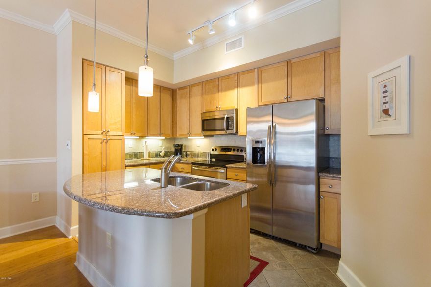 Seller accepting back up offers. This is one of the premier units with excellent courtyard and partial pool views. The nicest designed and laid out project around. The unique design of the buildings and the adjoining parking garages and in fact the entire project sells itself as soon as you enter the resort like complex. This particular unit is situated so you have very easy access from your covered parking with no stairs to climb and mid leveled floor for complete privacy.  With a patio that enjoys excellent views over the landscaped courtyards. In the unit the layout is superb with 2 separate bedrooms and  large bathrooms along with  granite counters throughout, large spacious tubs and showers  and a open kitchen full of Stainless steel appliances.