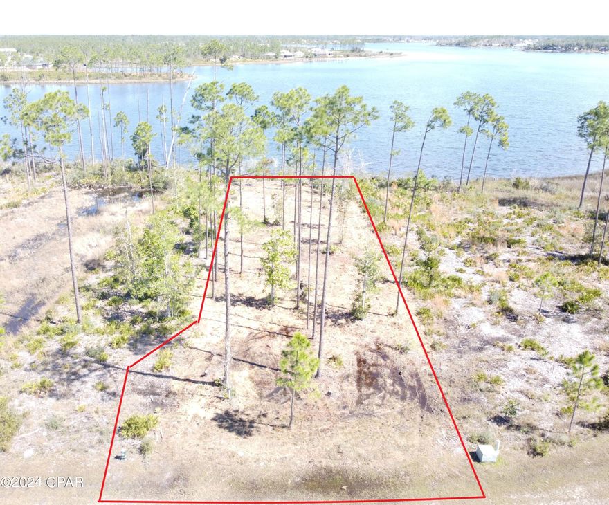 One of the best waterfronts in Laird Point is now available! Located at the tip of the peninsula! Superb year-round water depths to accommodate large vessels.  No worries of low tides or low bridges stopping your access to the Gulf of Mexico. Nice depths right behind the lot, so no need for a long dock. The lots on the peninsula are extremely valuable because you can get panoramic views, breezes off the bay, and your boat is protected on the east side of the peninsula. Also, this is one of the rare lots with no wetlands on it, making the whole lot usable. Laird Point is a gated waterfront community boasting ribbon curbed streets and underground city utilities. Amenities include a tennis court and rv/boat storage. Beautiful coastal style homes throughout the community. No pre-set time to build, so you can lock in your spot now, and then build when you are ready. Great proximity to TAFB and Mexico Beach. Full service marina with boat launch just minutes away. Schedule your visit today!