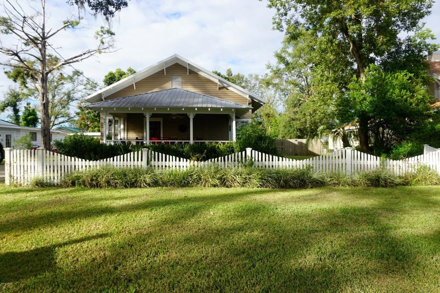 Beautifully remodeled home in downtown Marianna. This home has been lovingly cared for and has 3 bedrooms & 2 full baths. The home has 10 foot ceilings, original hardwood floors, updated kitchen cabinets, appliances, and counters, renovated bathrooms w/ tiled floors. The master bedroom has his & her closets (one is walk-in), and tiled shower. The extra bath was a tub/shower insert. Carpet in bedrooms has just been replaced 2019. HVAC unit is only a few years old. Roof & hot water heater & siding was done in 2011. The backyard is privacy fenced & has a deck overlooking it. Enjoy this spacious front porch & quaint neighborhood.