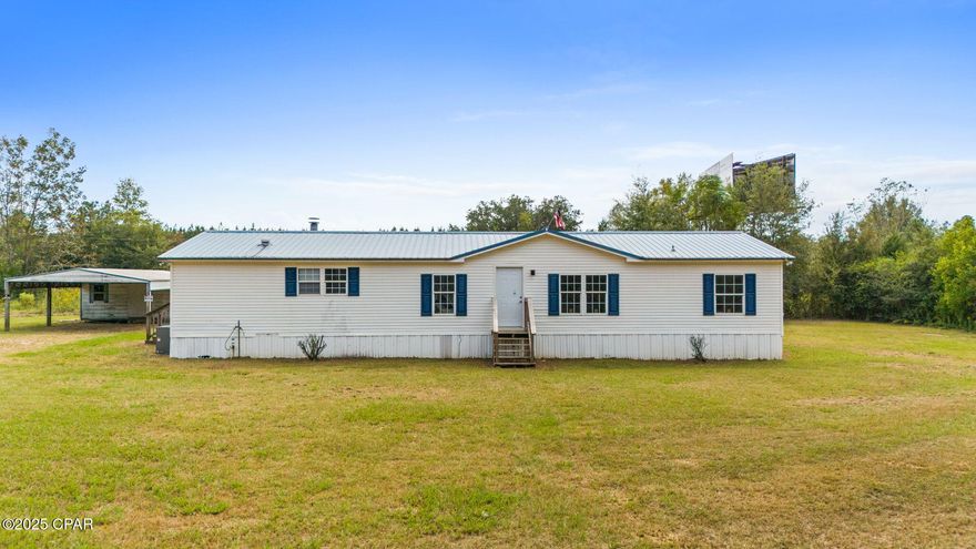 A Beautiful 3/2 on spacious 1.76-acre parcel. Great location, right next to I-10 and Hwy 231. Metal roof and a new 2025 Hvac, A spacious, open concept floor plan featuring a fireplace and luxury vinyl plank throughout. Nice master suite with double vanities, separate tub and shower. Large covered back porch. Two additional buildings, one metal with a carport, and the other an older block carport with storage. Priced to sell. Schedule your visit today!