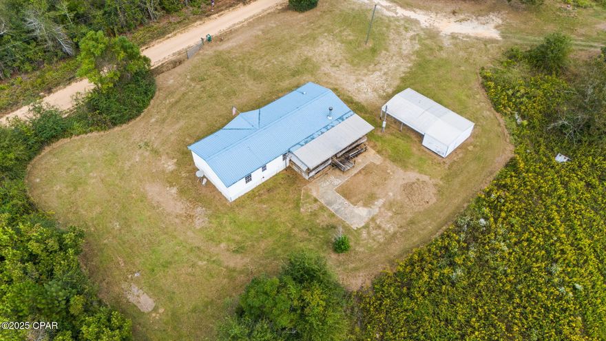 A Beautiful 3/2 on spacious 1.76-acre parcel. Great location, right next to I-10 and Hwy 231. Metal roof and a new 2025 Hvac, A spacious, open concept floor plan featuring a fireplace and luxury vinyl plank throughout. Nice master suite with double vanities, separate tub and shower. Large covered back porch. Two additional buildings, one metal with a carport, and the other an older block carport with storage. Priced to sell. Schedule your visit today!