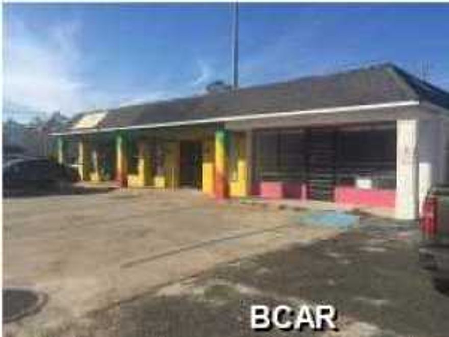 This building is a great buy. There are three spaces (bays) in the building. One space is occupied by the Jamaican Grocery on a month to month basis. The traffic counts are high and it is very centrally located to the beach residents and tourist related business and population. There is ample parking in the front and some parking in the back of the building.