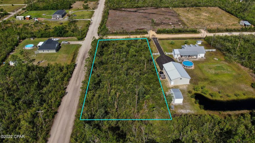 Property is raw land, uncleared.  It's a 1 acre corner lot with electrical service at the street.  Land use SFR.  The property has no mailing address.  Next door neighbor address is 2201 BJ Drive