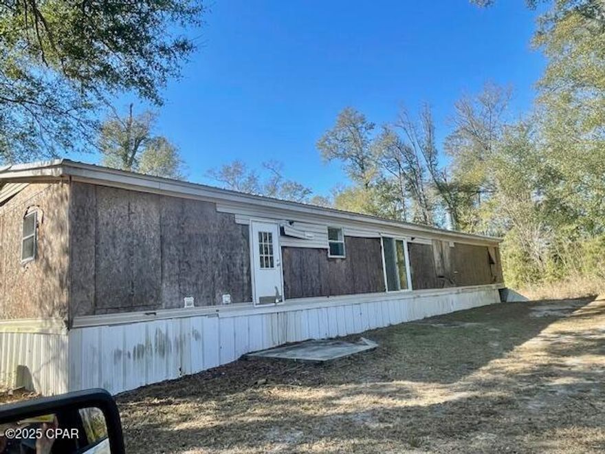 This is a large 5 bedroom 3 bath manufactured home in the country on 1 acre of land.  It has been vandalized but would make a good investment property.  The true address should be 5845 Blocker road with a 30x450 ft. easement taking you down to the home.  The easement was never opened and it is overgrown and would need to be opened up and a road made to get to the property.