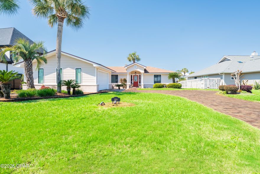 Nestled within the private, gated community of Bay Point, this stunning 3-bedroom, 2-bath waterfront home embodies the relaxed coastal lifestyle, centered around beautiful water views. The home features a bright sunroom and a spacious deck overlooking the canal - perfect for enjoying Florida's year-round outdoor living.

As you arrive, you'll be welcomed by a beautifully manicured yard with lush tropical landscaping. The brick paver driveway includes a convenient side parking area beside the two-car garage, offering plenty of space for vehicles, water toys, or even a golf cart. Situated on a large lot with approximately 70 feet of canal frontage, the property offers picturesque water views where two canals meet.

Inside, a welcoming foyer opens to vaulted ceilings, abundant natural light, and an open-concept living space designed for easy Florida living. The living room features a cozy wood-burning fireplace, tranquil canal views, recessed lighting, and a built-in entertainment center complete with a convenient wet bar that serves both the living and dining areas.

The spacious modern kitchen is ideal for entertaining and everyday living, offering generous cabinet and counter space, a pantry, breakfast area, and a center workstation island - perfect for preparing meals or gathering with guests.

The primary suite is privately located on the opposite side of the home and includes an oversized custom walk-in closet and a dedicated office space overlooking the water. The spa-like primary bathroom features a soaking tub, walk-in shower, and dual vanities. Both the office and living room provide access to the waterfront sunroom, creating a seamless indoor-outdoor living experience.

Just outside the sunroom, a large open deck leads down to the seawall and private boat dock, offering ample space for larger boats. From your backyard, enjoy a scenic boat ride through Bay Point's canal system to the open bay and nearby Shell Island.

Residents of Bay Point enjoy 24/7 roving security, golf-cart-friendly streets, a Jack Nicklaus-designed golf course, a full-service marina, scenic canals, and an on-site restaurant. The home is also just a short drive from St. Andrews State Park, the ''World's Most Beautiful Beaches,'' as well as local dining, shopping, and entertainment.

This exceptional property perfectly blends comfort, style, and the ultimate waterfront coastal lifestyle.