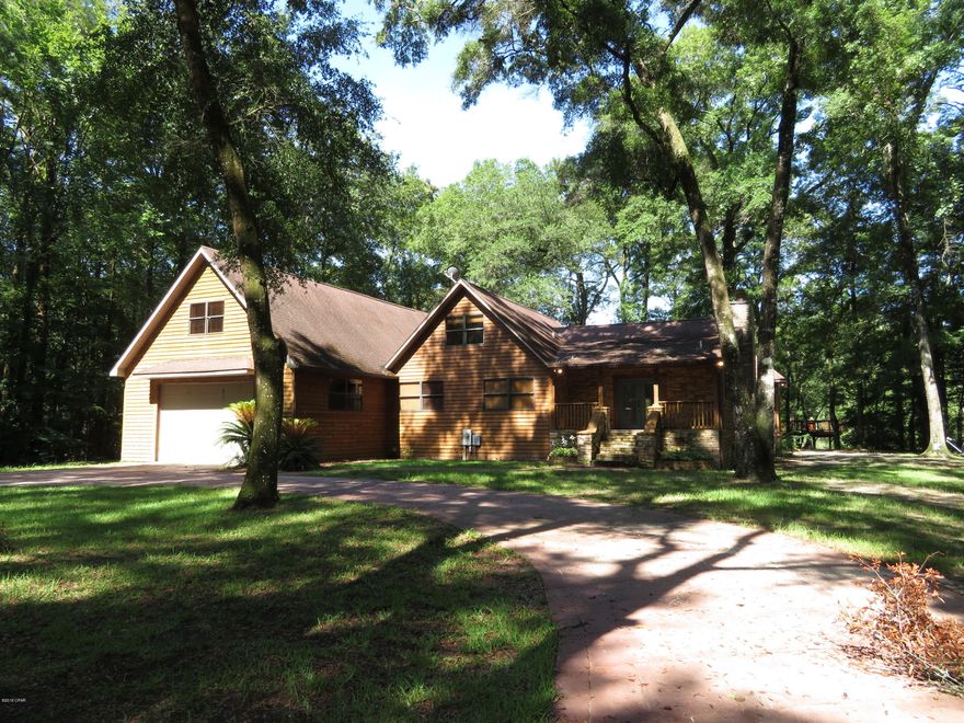 Waterfront Paradise tucked away in wooded privacy on the scenic Econfina Creek. Originally built in 1992 but totally renovated in 2007 by a distinguished builder as his personal home so just imagine how nice! The huge kitchen/dining room has 20 ft ceilings, hand carved solid oak flooring, cathedral wood ceilings, hickory cabinets, stacked stone, tile, nice appliances and bronze tinted/insulated picture windows displaying the beautiful view of the grounds and creek. The living room displays a stunning stacked stone fireplace, hand carved solid oak flooring, and cathedral wood ceilings. A home theater room is upstairs with a custom kitchenette & bathroom. This area is sound resistant and pre-wired for speakers. The home office is next to home theater. The waterfront docks include a brick paved boat ramp, a drive on boat ramp; remote controlled, tree-brella with tree-table, which leads to the tree house/clevage deck with tree-tables, flowering vines, and beautiful views of the creek and wildlife. Econfina Creek is spring fed and perfect for canoeing, kayaking, fishing and tubing. Willford Spring is an easy canoe trip just 1.5 miles from here and is absolutely beautiful. You'll love the wildlife of all kinds you can see from the house too. This amazing home has many areas not included in the heated/cooled square footage such as a state of the art out-door kitchen showcasing a stainless steel rotisserie grill with hood, smoker, bar sink, sitting area, and full bar with stacked stone and solid wood Australian Cypress counter tops. There is a marvelous screened-in hot tub room coming out of the master bedroom through double French doors. This steps down to another deck overlooking the creek and leading to the outdoor kitchen/living area. There are multiple "man cave" areas including a 954 sq ft garage that can hold 4 cars. Outside is a heated/cooled workshop that could be turned into a mother-in-law suite. Under the house is a massive amount of space for storage and a panic room or tornado shelter. The home has a music and security system piped both inside and out. There are many more surprises that you'll want to see for yourself in this amazing dream home.