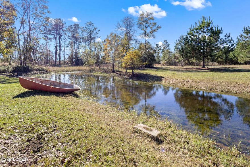 Rare 20-Acre Gated Retreat with Mother-in-Law Quarters located in Ponce De Leon Florida! 5-bedroom, 3-bathroom private, versatile, Move-in-Ready residence featuring a desirable split floor plan and dedicated mother-in-law quarters with a private entrance, perfect for multi-generational living or guests. Enjoy the quintessential Florida lifestyle on the massive wrap-around porch overlooking your completely fenced and gated 20-acre estate.  Durability & Stylish long-lasting metal roof, and fresh interior/exterior paint, and New Flooring. Includes a chicken coop and a large storage building/metal warehouse--ideal for hobbies, equipment, or a workshop. 20 level acres offer endless possibilities for expansion, gardening, or another private homestead. Home is a short drive to stunning natural springs while maintaining easy access to modern conveniences. All information is approximate; buyers to verify all deemed important. Furniture does not convey. Call today to see this home!