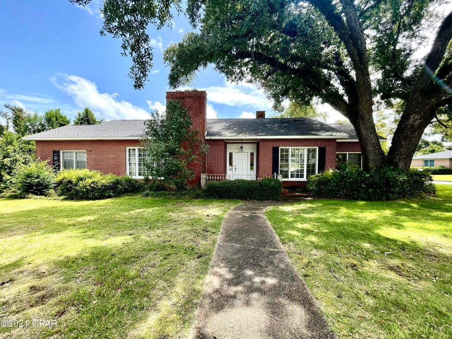 Attention Mid-century lovers!! This home is a true step back in time and in the best way! This home features almost 10 ft tall ceilings on a large corner lot on a quaint street in downtown Marianna. The home is situated under a huge oak tree and has mature landscaping that with a little trim would look beautiful as it is. The home features a spacious living room with wood burning fire place, formal dining room, den with unique parquet wood ceiling, and large kitchen with breakfast room. There are three bedrooms in the main part of the home with two full bathrooms. Above the attached garage and through a little sunroom with terrazzo floors is an additional bedroom and full bathroom as well as a half bathroom. The roof was replaced in 2019. This home is a true gem, it is just in need of some TLC to bring it back to its full potential.