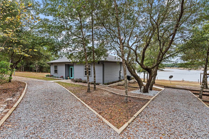 Welcome to 4958 Lake Ridge Road — a rare opportunity to own over 5 acres of manicured, waterfront paradise on beautiful Long Lake.

This secluded property offers complete privacy with no neighbors in sight, a fully fenced perimeter, and exclusive access through an HOA-maintained security gate, ensuring peace, quiet, and security at all times.

Step onto the expansive back deck and take in panoramic lake views with over 200 feet of pristine lake frontage. Watch bald eagles nest across the property, see deer wander to the water's edge, and enjoy some of the area's best bass fishing just steps from your home. Boats are allowed, making this the ideal retreat for anyone who loves life on the water.

The land itself is beautifully maintained with orange and lime trees, wide-open green space, and plenty of room for animals — horses are allowed.

A versatile 18x25 detached, insulated garage offers ideal storage or workshop space, and the adjoining air-conditioned dog pen provides comfort for pets year-round. Inside the home, enjoy modern conveniences including peaceful lake views from multiple vantage points.

Located in a NO flood zone, this property combines natural beauty with security and usability — the perfect blend of homestead, hideaway, and lakefront living.

Experience unmatched privacy, wildlife, and waterfront living at 4958 Lake Ridge Road. Properties like this rarely come available.