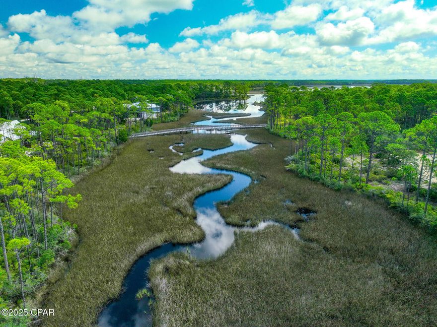 Make an offer and build your dream home on this premier, oversized lot in RiverCamps at Crooked Creek! This impressive 57' x 327' homesite is one of the deepest lots in the community, offering exceptional privacy and peaceful water views of Crooked Creek. Mature oak trees are scattered throughout the property, creating a beautiful natural setting ideal for your custom home.The lot is within easy walking distance to the newly renovated pool and community amenities and also includes home plans, a topographical survey, and a lot survey, saving you time and expense in the building process.RiverCamps is a gated, waterfront community known for its unique outdoor lifestyle and outstanding amenities, including: Boat storage, Boat dock & launch, Washout stations, Public bathhouses, Walking trails, Campfire areas & glamping tents. Located in one of Panama City Beach's fastest-growing areas, RiverCamps offers convenient access to the new hospital, Pier Park, shopping, dining, and the world-famous beaches. This is a rare opportunity to secure one of the most desirable and private lots in RiverCamps—schedule your showing today!