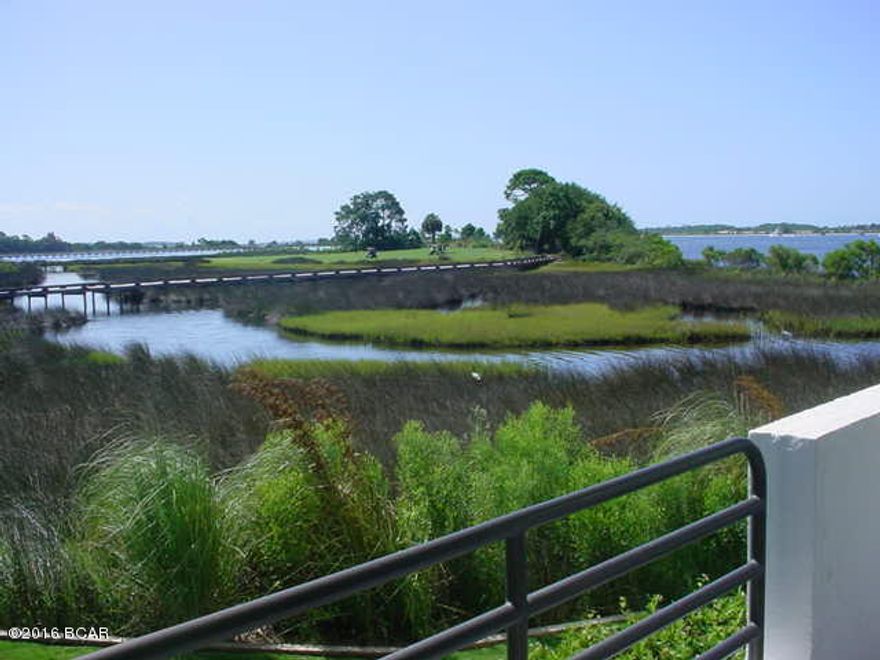 Totally remodeled, beautiful unit.  Even though this is a ground-floor unit, its elevation makes for a very nice view of the Bay, golf course and pass.  The flooring is vinyl plank, the counter tops are granite in kitchen, bath and wet bar.  Stainless steel appliances in kitchen with new cabinetry.  This is a must see unit.  In addition to the monthly condo fee of $376, there is an annual Bay Point Community Association fee of $1325.