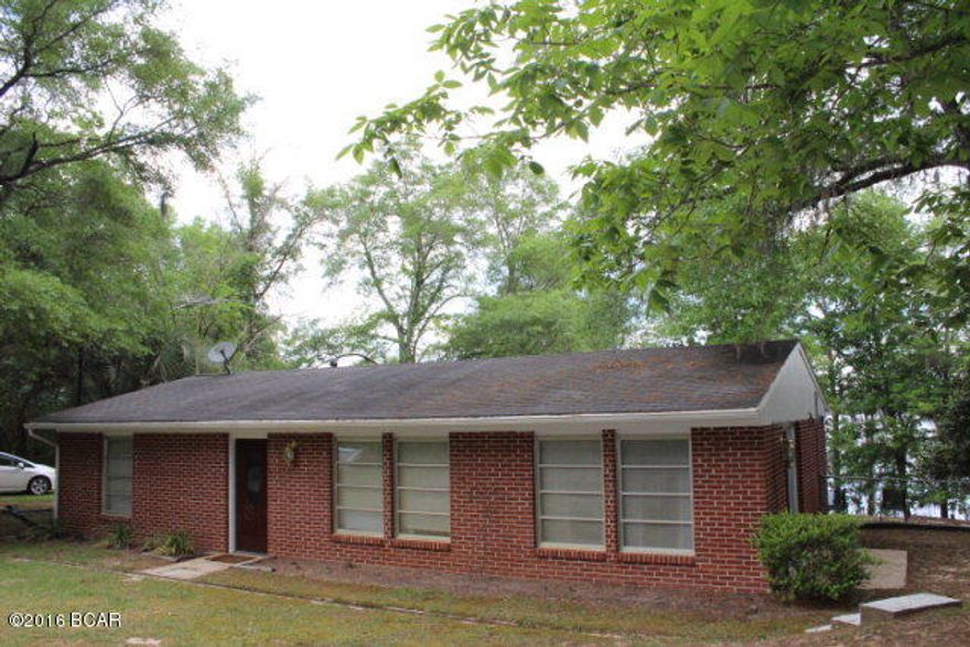 LAKE FRONT PROPERTY! REDUCED!!! This amazing 1.2 acre (MOL) property is situated on the beautiful Compass Lake, and the views are stunning! Let all of your cares and worries melt away with each passing second that you soak in this awesome atmosphere! There really are too many amenities to list here! You will enjoy this 1300 sq ft 3/2 brick home, that feels like a spacious lake cottage! It is already set up for expansion with its own non-shared water well, and an upgraded septic system. Did I mention the lot is 1.2 acres!!!(MOL) House has fresh paint, and is move-in ready! You will enjoy the Florida room on the back of the house with its fantastic views, and the 44 ft freshly painted dock. SELLER SAID MAKE OFFER. with 191 ft of lake frontage!!! WOW!reduced SELLER SAYS MAKE OFFER