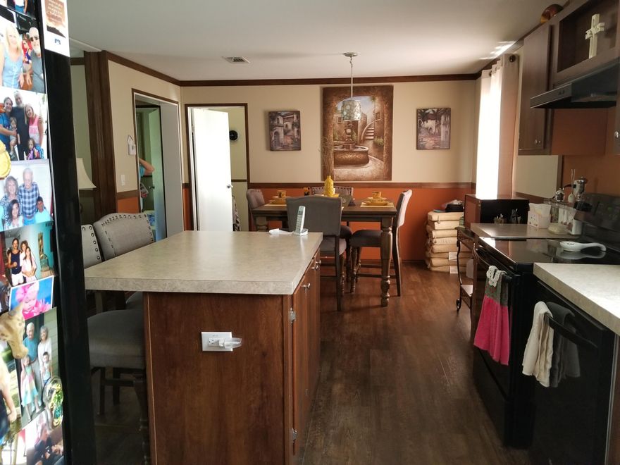 'CURRENTLY UNDER CONTRACT, SELLER ACCEPTING BACKUP OFFERS' This 3 bedroom, 2 bathroom home has been very well maintained and looks brand new. A split bedroom design, it has modern colors and wood plank vinyl floors, no carpet. It has an open floor plan and seems bigger than other plans. The kitchen features lots of cabinets, black appliances, pantry, and a breakfast bar/island with extra cabinets below. The master bathroom has two sinks, a soaking tub, a shower with two seats, and plenty of cabinets.  There is an open deck on the front and back with a ramp for easy access. Out back is a metal carport and a 12x24 storage building that has an air conditioner. It is a private setting on 3.6 acres and about 2.5 acres remain wooded. It is in a security gated lake subdivision.