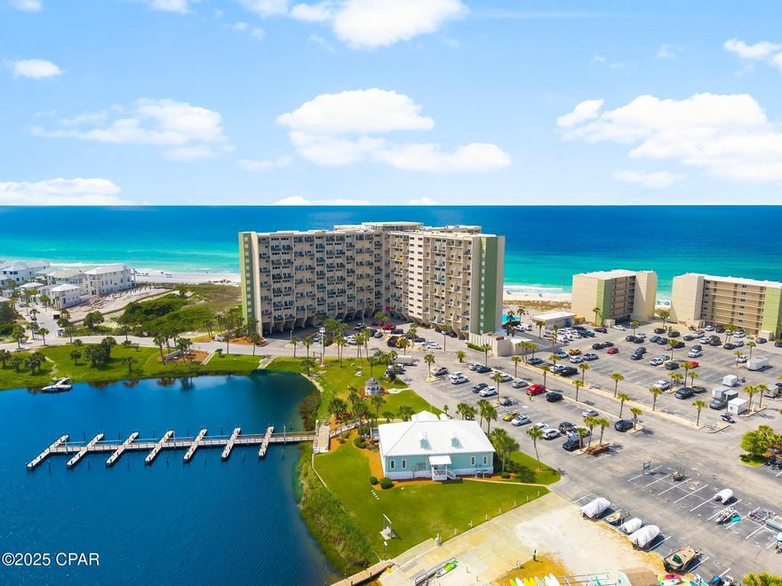 Experience elevated coastal living in this beautifully updated 3-bedroom, 3-bath penthouse at Pinnacle Port, offering stunning Gulf and Lake Powell views from nearly every room. This 1,244 sq ft turnkey residence features two spacious master suites with updated tile showers (two with glass enclosures), a guest suite overlooking the lake, and a blend of tile and luxury vinyl plank flooring throughout, including the balconies.

The kitchen is appointed with granite countertops and opens into a bright Gulf-facing living area with access to a private balcony. Sold fully furnished, the unit is ready for personal enjoyment or immediate use as a short-term rental investment. A private owner's storage closet on the main floor is also included.

Located in a gated, 24/7 secured community, Pinnacle Port offers an impressive array of amenities including beach and lake access, two pools, sauna, fitness center, tennis and pickleball courts, boat dock and launch, fishing pier, basketball court, picnic areas, grilling stations, and a playground currently being updated.

Ideally positioned near 30A, Pier Park, and Destin, this property delivers the perfect blend of luxury, convenience, and investment potential.