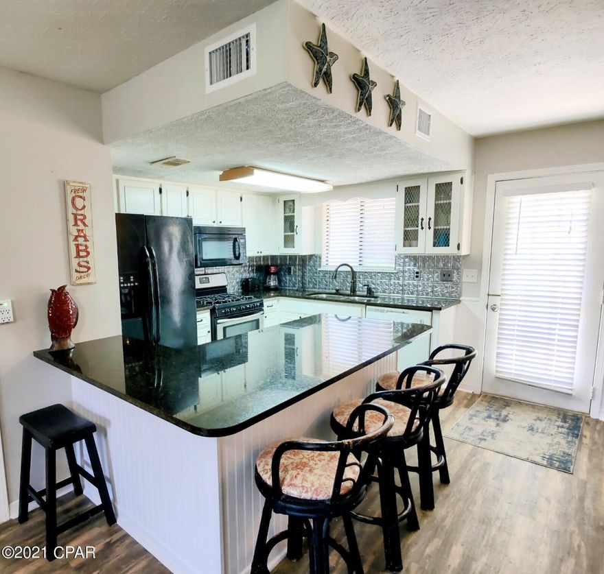 Gulf Highlands Beach Resort has 797 units and is located across the street from The BEACH. This 2 BR has 1.5 Baths and is an END UNIT with 2 Parking Places PLUS a Golf Cart spot. Newer Roof, Vinyl Floor Planking, Granite Counters... come check it out!!! Resort Amenities are 11 Pools ''5 Heated'', 4 Tennis Courts '' 2 Lighted'', Fitness Center, 18 Hole Mini Golf, 2 Playgrounds, Shuffleboard Courts, Conference Center, and a Private Club House with a Snack Bar on The Beach along with 1 of the 11 Pools. Walking Distance to several Attractions, Dining, Shopping, Post Office, and Walmart.    Age, SF, and Dimensions are approximate.... please verify if Important.